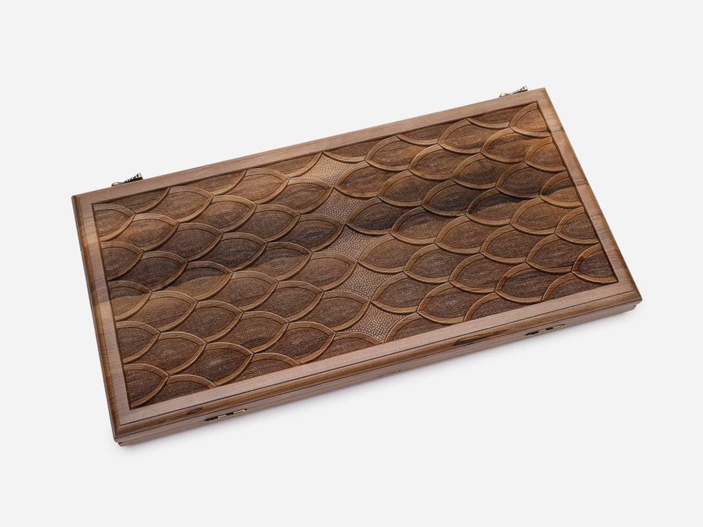 Angled view of the fish-scale engraved backgammon board