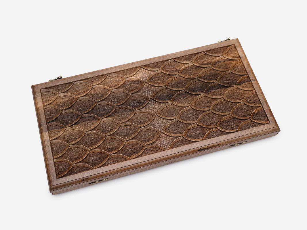 Angled view of the fish-scale engraved backgammon board