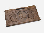 Angled view of the ornate medallion carved backgammon board