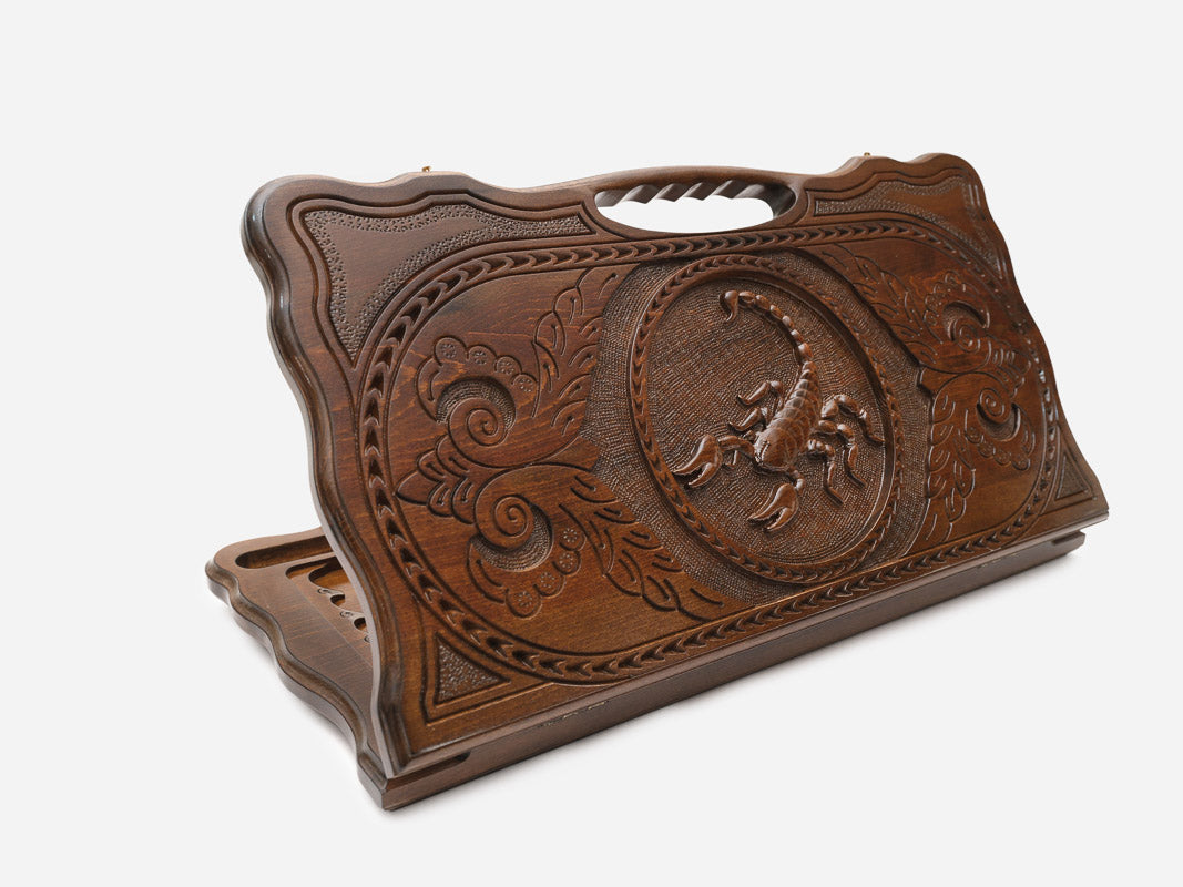 Carved beechwood backgammon board with a scorpion medallion and a carry handle, propped open