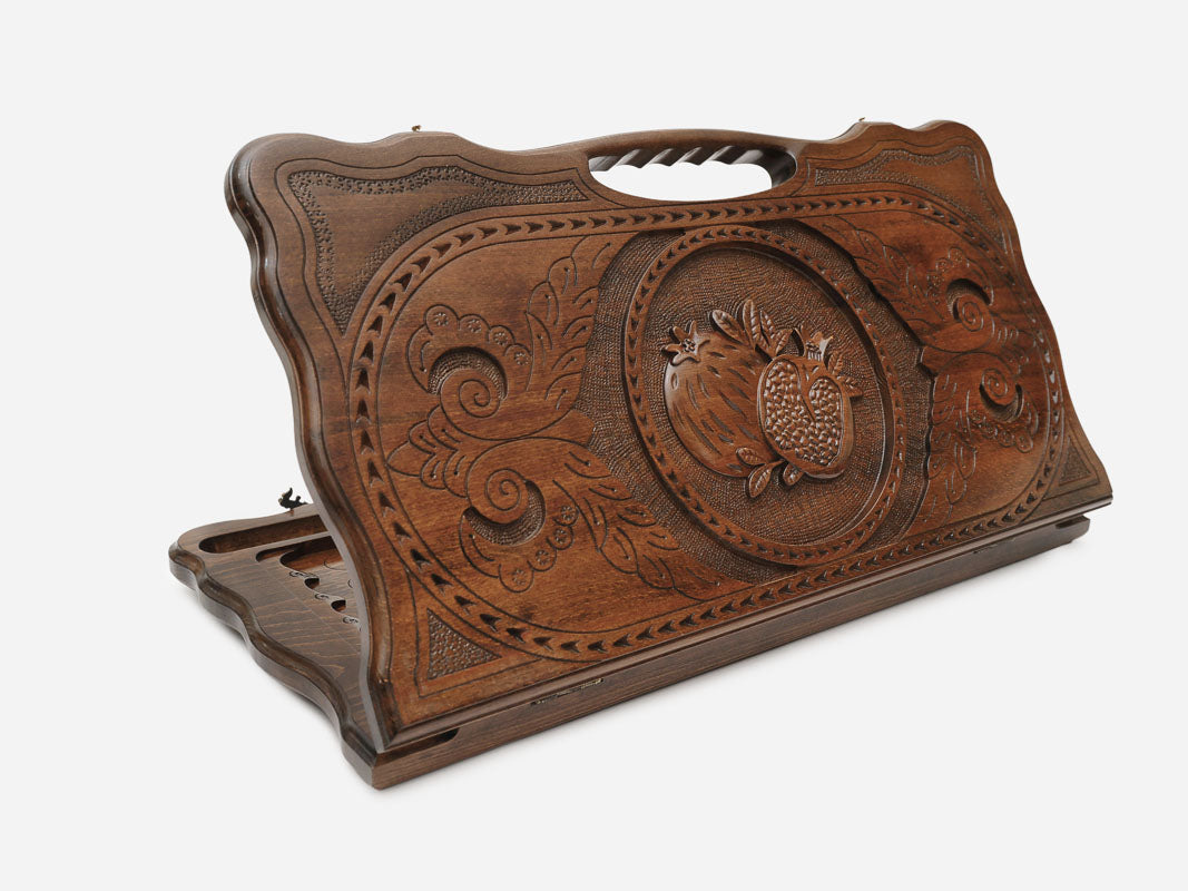 Carved beechwood backgammon board with a pomegranate medallion and a carry handle, propped open