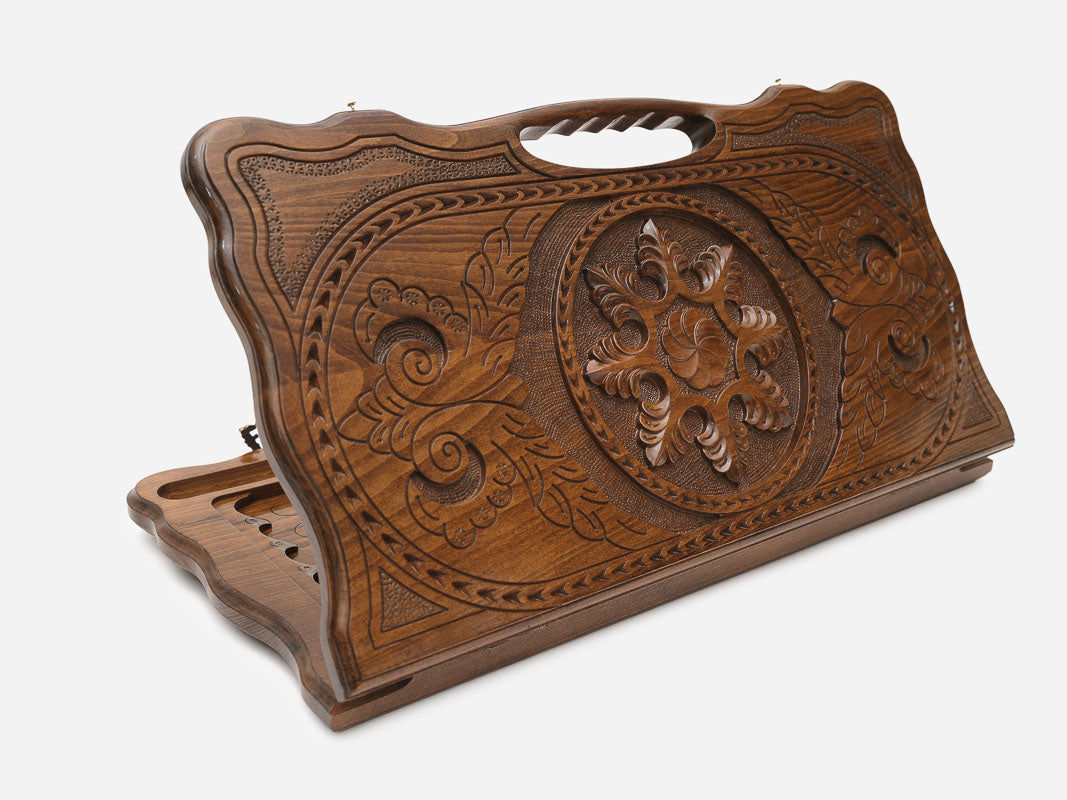 Carved beechwood backgammon board with a snowflake ornament medallion and a carry handle, propped open
