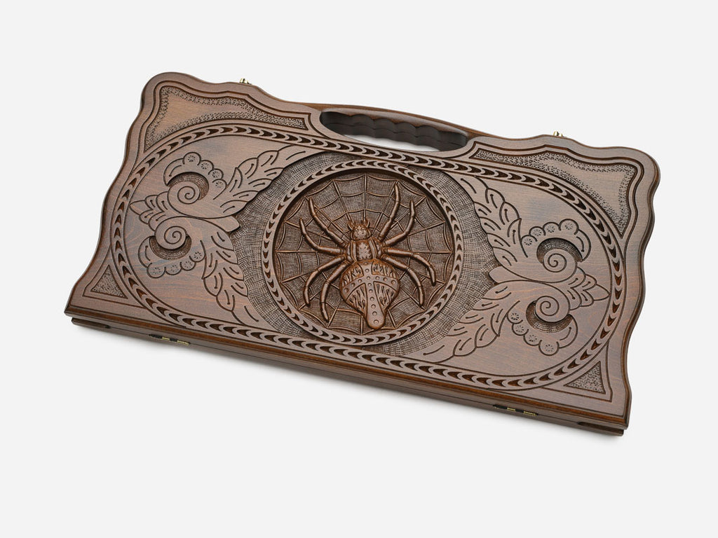 Angled view of the spider carved backgammon board