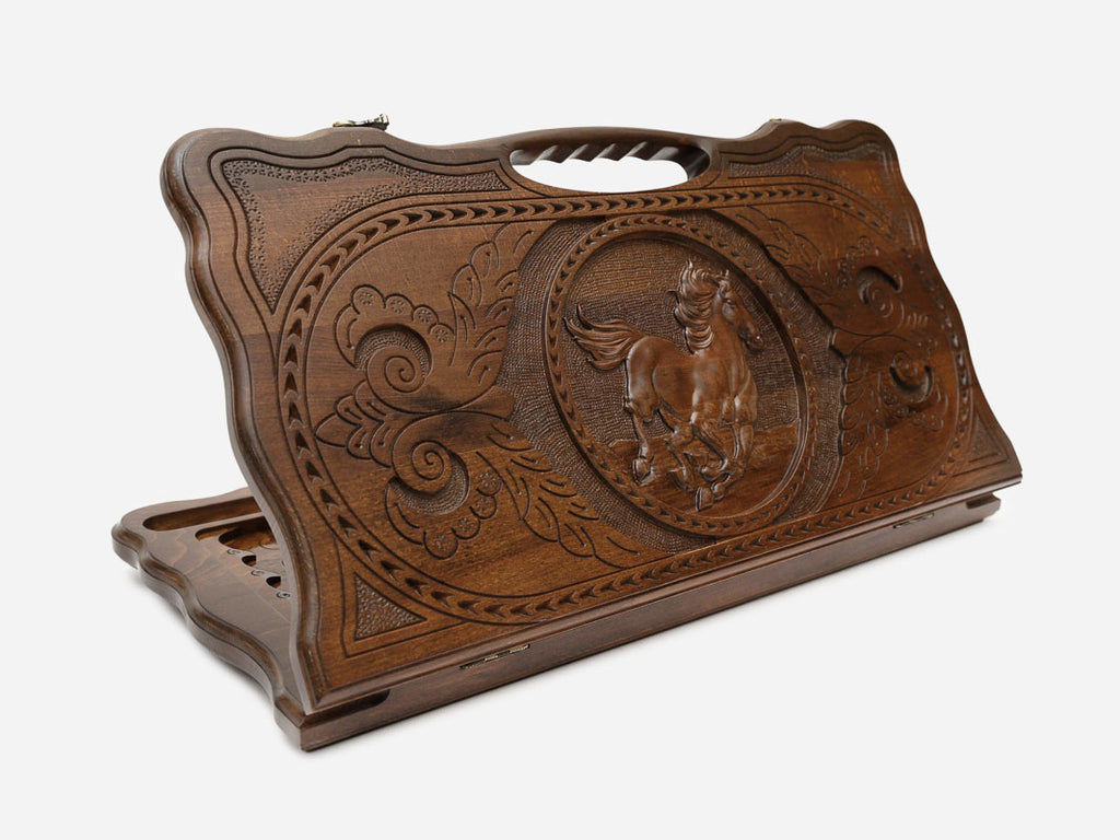 Carved beechwood backgammon board with a galloping horse medallion and a carry handle, shown propped open