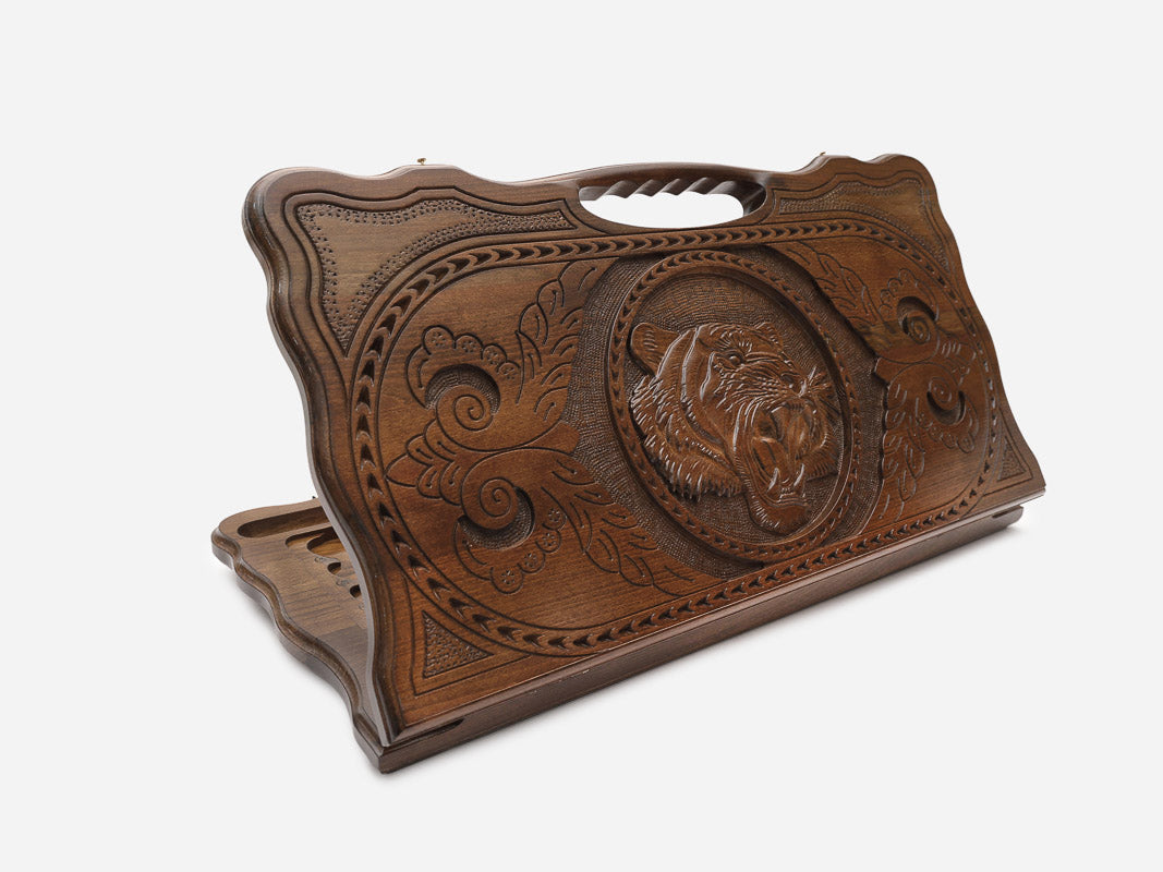 Carved beechwood backgammon board with a tiger head medallion and a carry handle, shown propped open