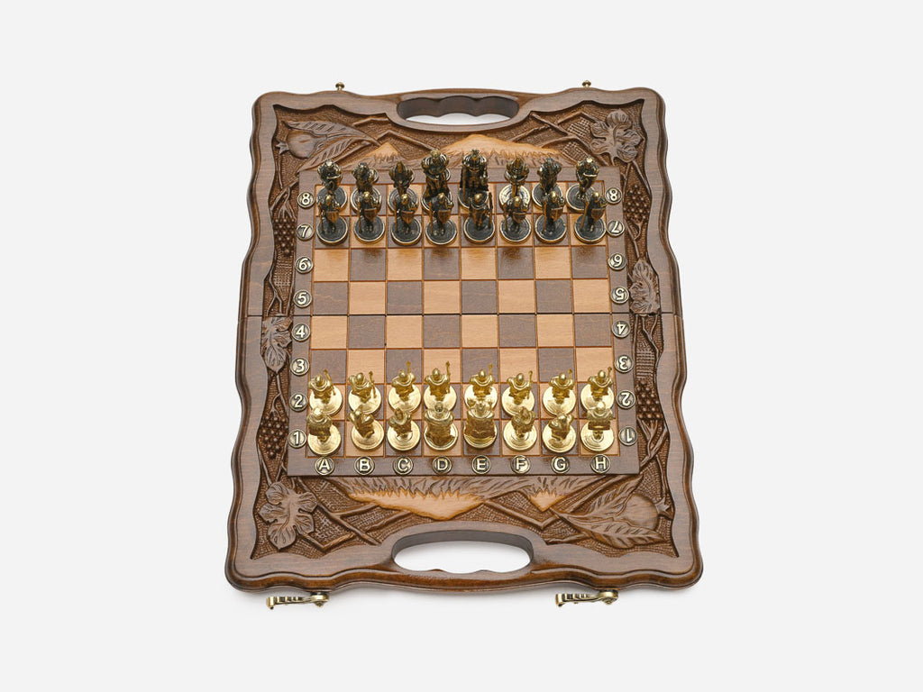 Close-up of gold and silver figural metal chess pieces