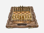 Walnut chess and backgammon set open to the chessboard with figural metal pieces