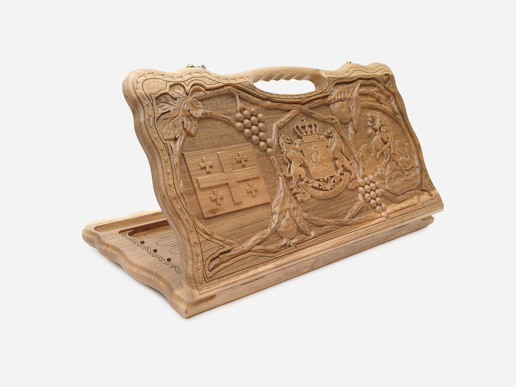 Carved walnut backgammon board with the Georgian coat of arms and cross, with a carry handle, propped open