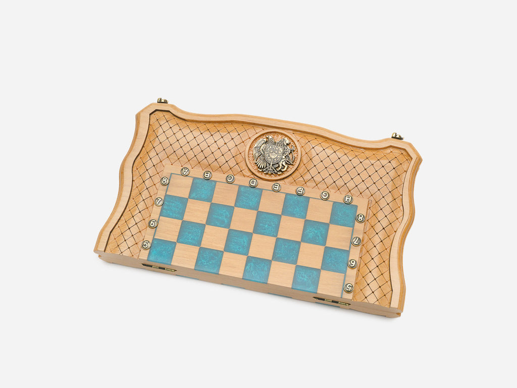 Full view of the opened turquoise epoxy chess board with light and dark wooden pieces set up