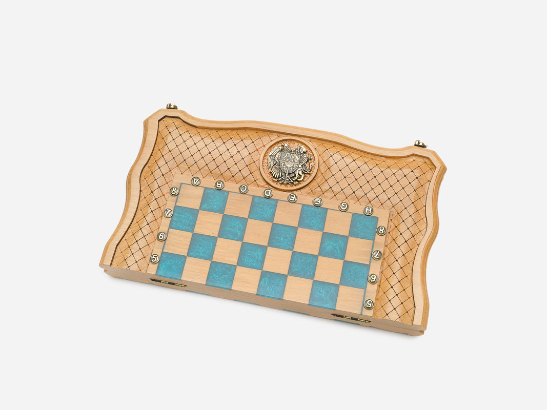 Full view of the opened turquoise epoxy chess board with light and dark wooden pieces set up