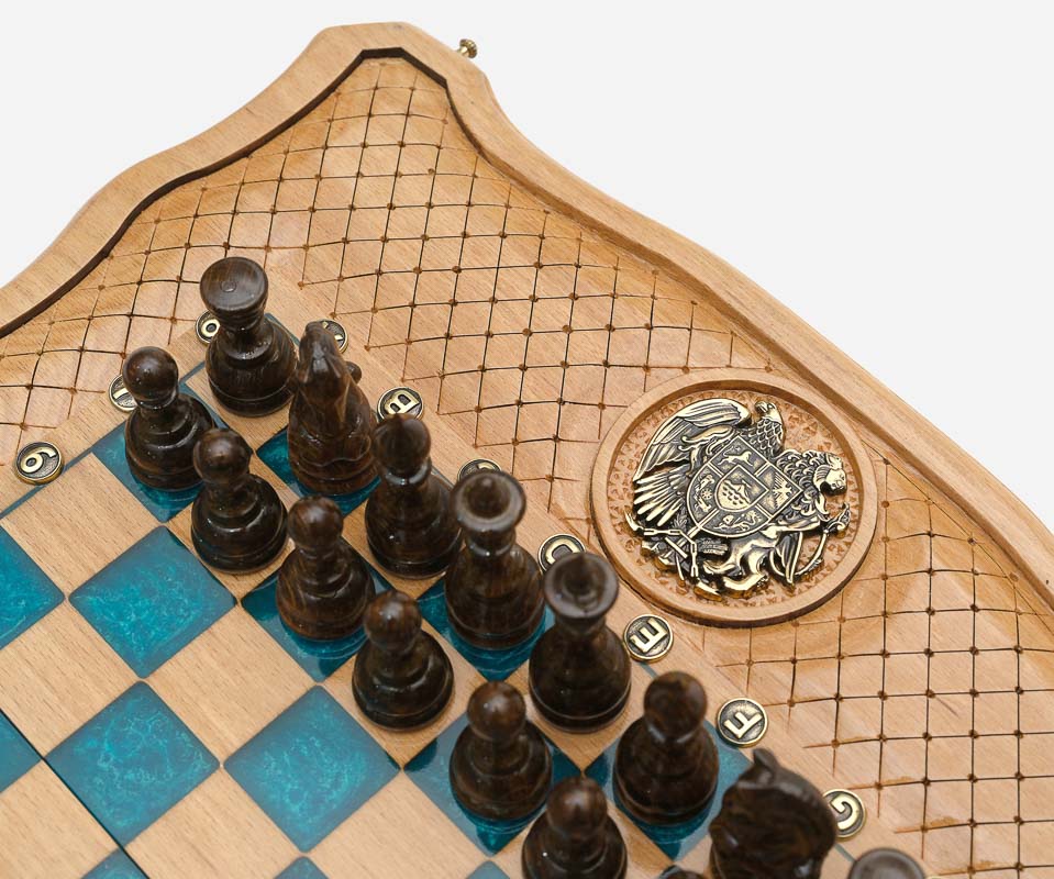 Close-up of the dark wooden pieces beside the inlaid coat-of-arms medallion