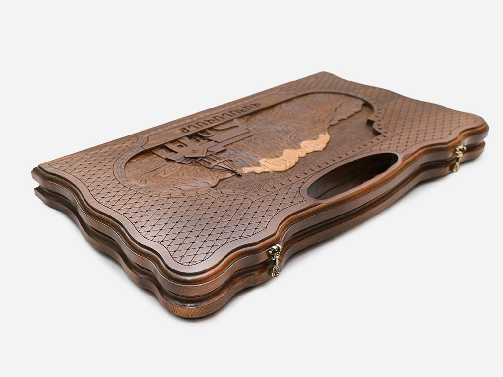 The backgammon board opened to show the wooden playing surface