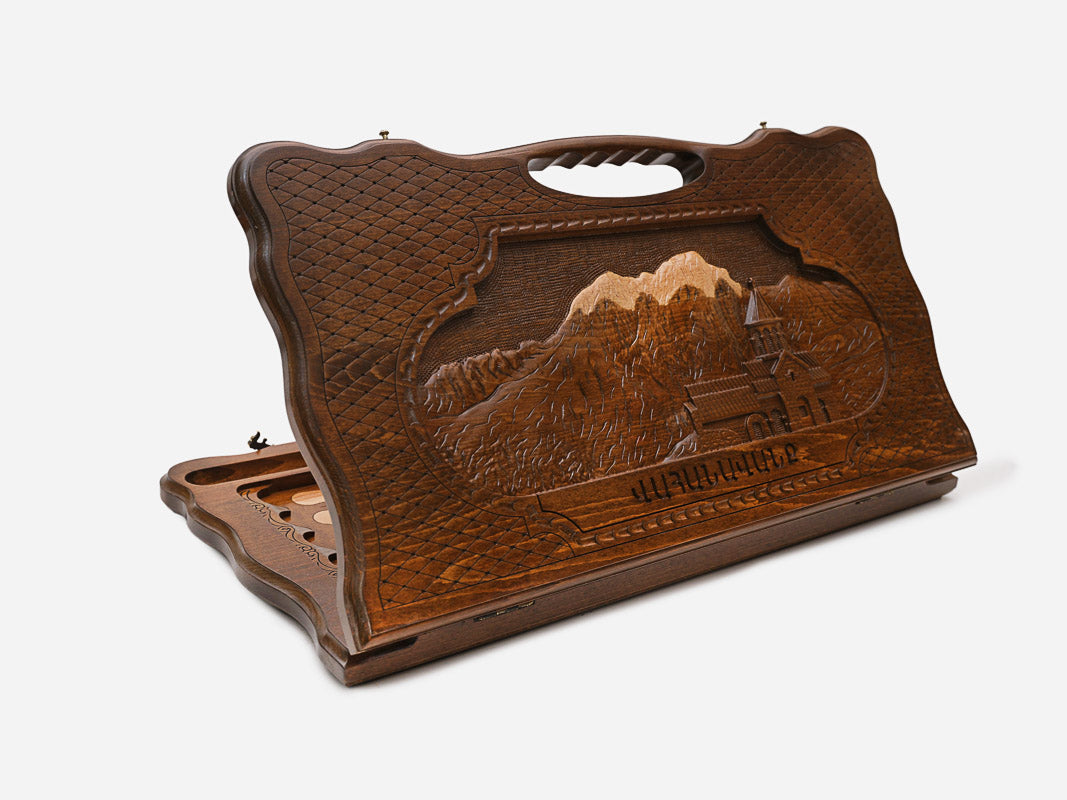 Carved beechwood backgammon board showing the Vahanavank monastery among mountains, with a carry handle, shown propped open