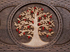 The ornate bronze carry handle at the top of the board