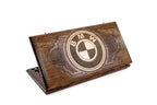 A frontal shot of the closed BMW classic backgammon board featuring the hand-carved circular logo.