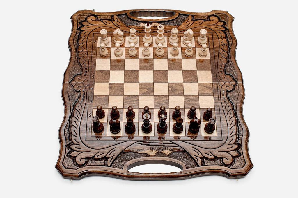Folding walnut chess board with carved scrollwork borders, a Mount Ararat inlay and beech and walnut pieces in starting position