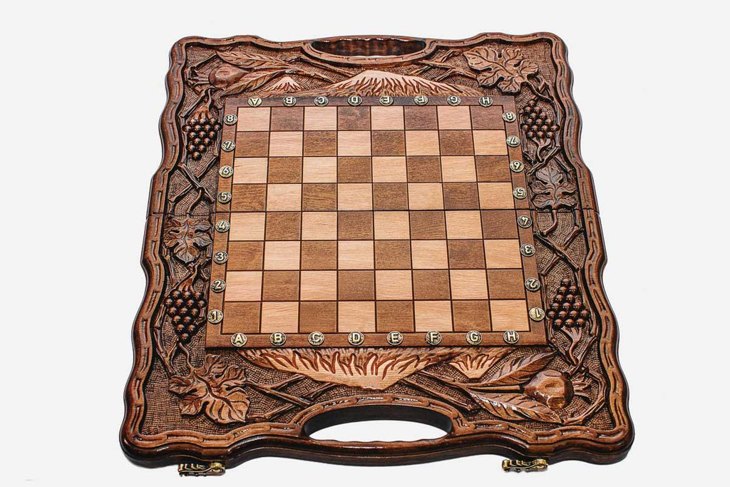 Angled view of the pomegranate and grape chess set with its wooden pieces