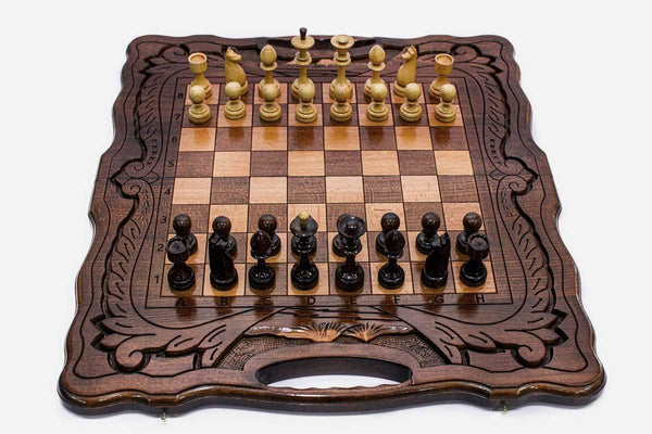 Folding walnut chess board with a Mount Ararat inlay, carved corners and beech and walnut pieces in starting position