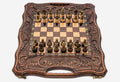 Folding walnut chess-backgammon board with deeply carved borders and ornate bronze chess pieces set up for play