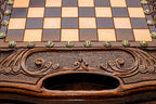 Close-up of the carved border, bronze coordinate markers and carry-handle cutout