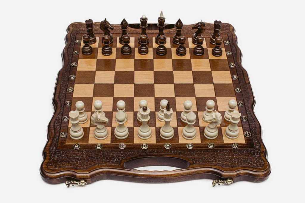 Close-up of the beech and walnut chess pieces on the inlaid squares