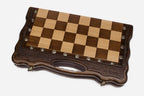 Close-up of the ornate bronze chess pieces on cream bases