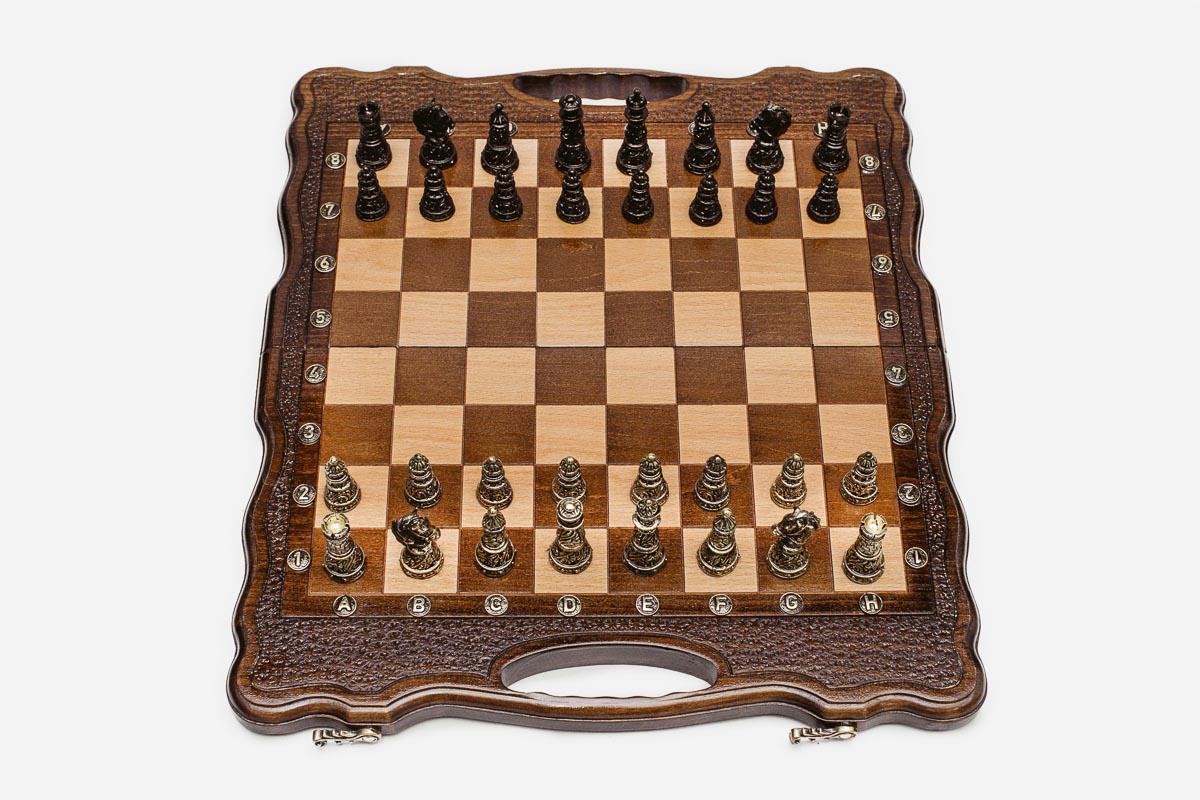 Folding walnut chess board with carved corners and ornate bronze figural pieces - dark and gold armies in starting position