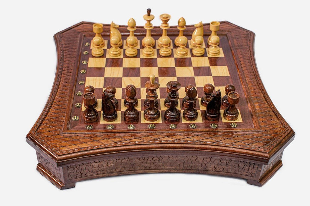 Curved-side wooden chess set with diamond-lattice border and Staunton pieces set up on the inlaid board