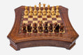 Curved-side wooden chess set with diamond-lattice border and Staunton pieces set up on the inlaid board