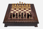Wooden chess set in dark walnut with a carved lattice and beaded border and Staunton pieces set up for play