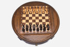Round wooden chess set with woven lattice-carved border and Staunton pieces set up on the inlaid board