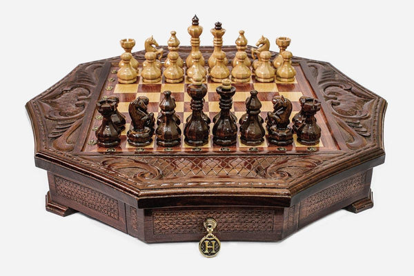 Octagonal wooden chess set in warm mahogany finish with carved acanthus corners and Staunton pieces set up for play