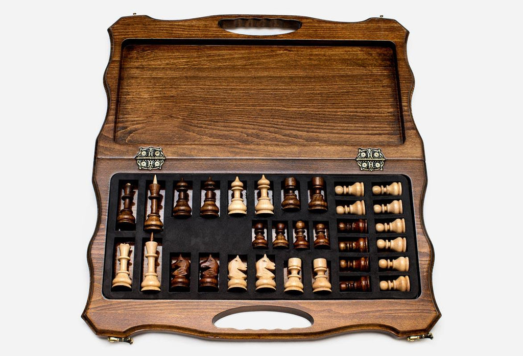 Overhead view of the chessboard and the full set of light and dark pieces