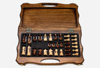 Overhead view of the chessboard and the full set of light and dark pieces