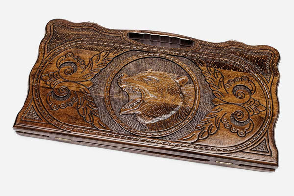 Carved beechwood backgammon board with a standing bear medallion and a carry handle, propped open