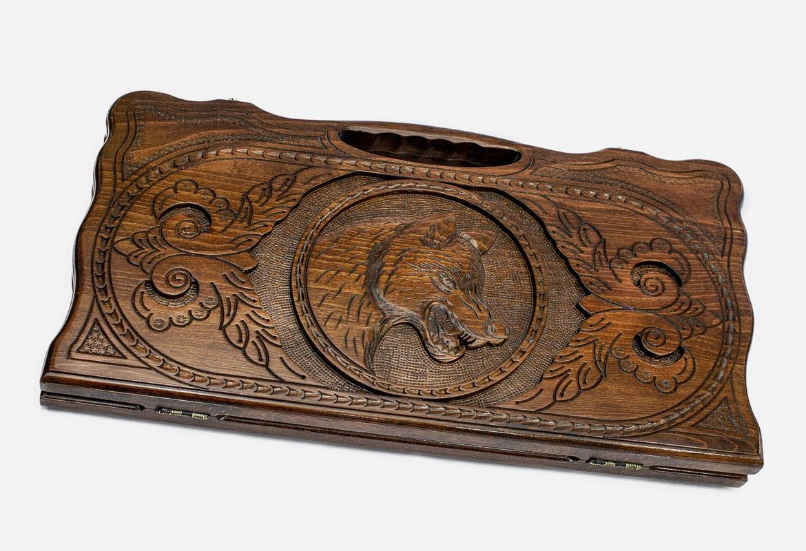 Carved beechwood backgammon board with a prowling wolf medallion and a carry handle, propped open