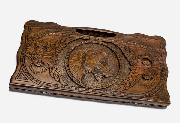 Carved beechwood backgammon board with a prowling wolf medallion and a carry handle, propped open