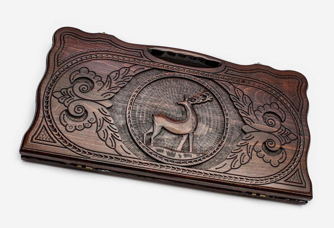 Carved beechwood backgammon board with a deer medallion and a carry handle, propped open