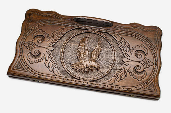 Carved beechwood backgammon board with an eagle medallion and a carry handle, propped open