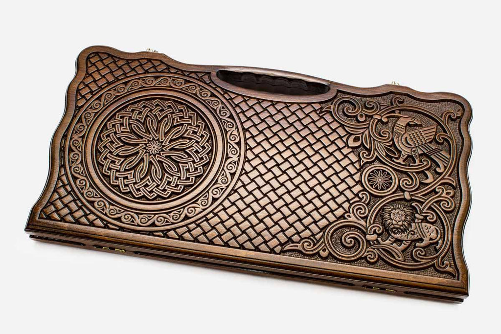 Carved beechwood backgammon board with a knotwork rosette and an eagle, propped open