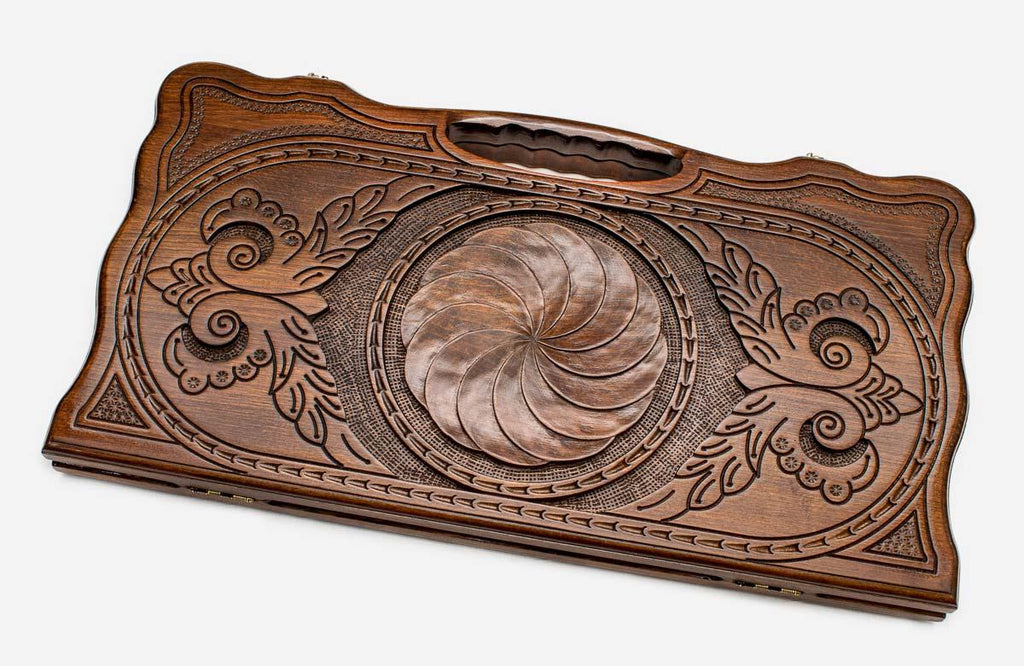 Carved beechwood backgammon board with an infinity medallion and a carry handle, propped open