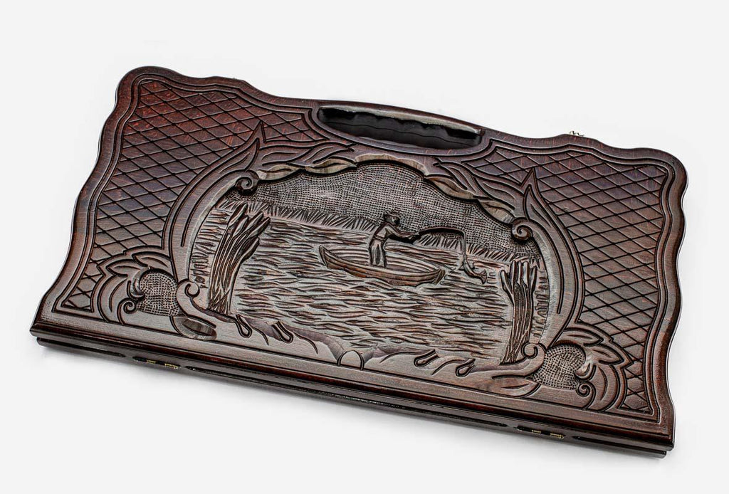 Carved beechwood backgammon board with a fisherman in a medallion, propped open