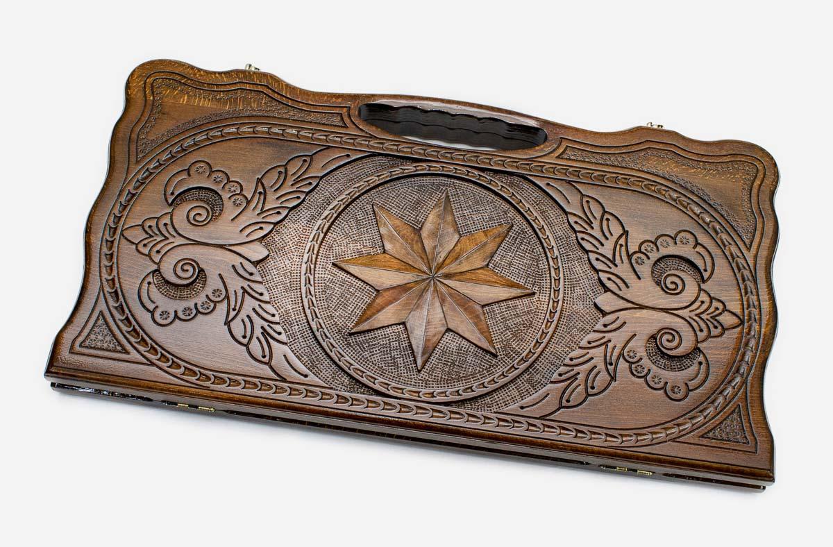 Carved beechwood backgammon board with an octagon medallion and a carry handle, propped open