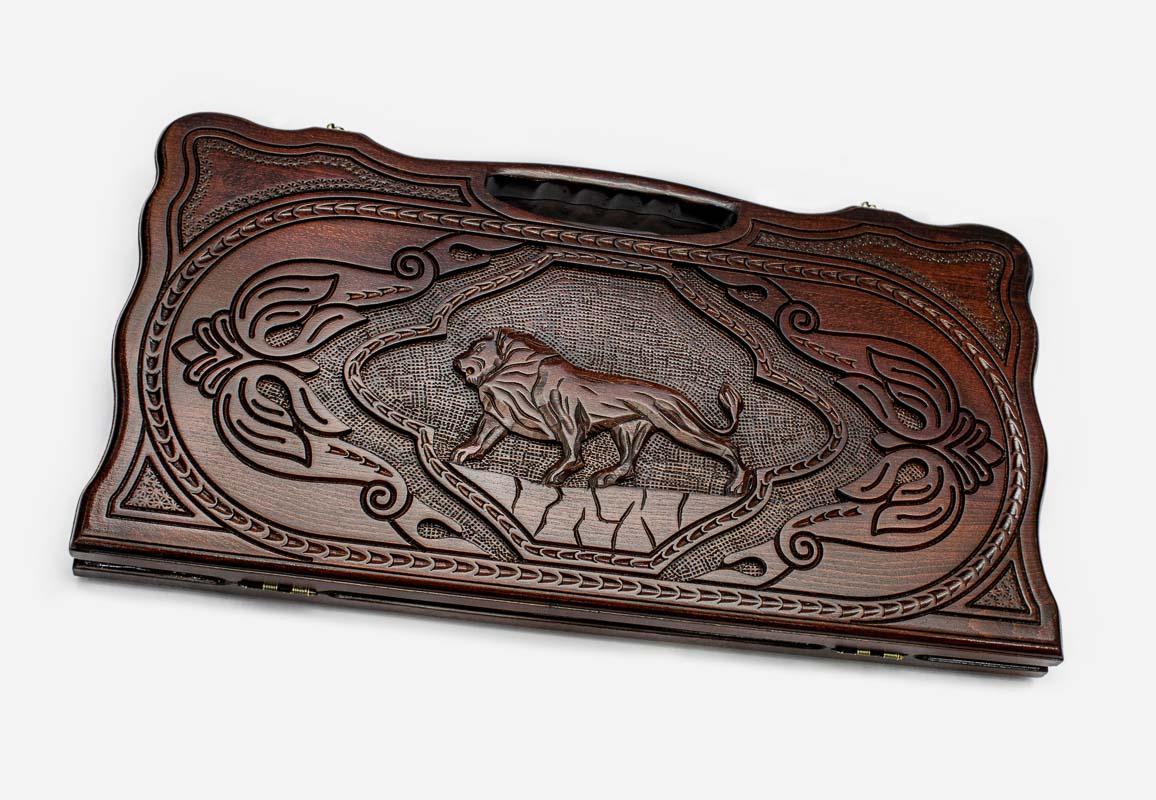 Carved beechwood backgammon board with a lion medallion and a carry handle, propped open