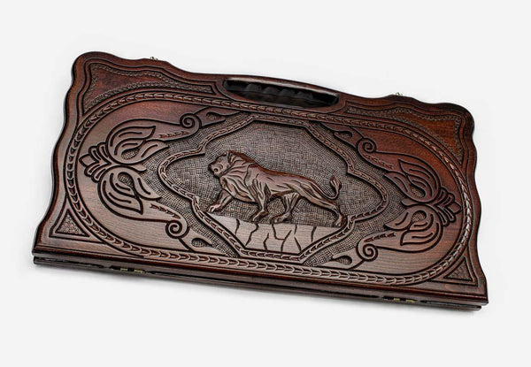 Carved beechwood backgammon board with a lion medallion and a carry handle, propped open