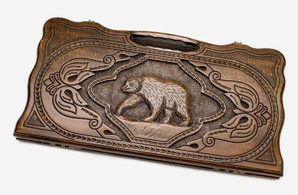 Carved beechwood backgammon board with a bear medallion and a carry handle, propped open