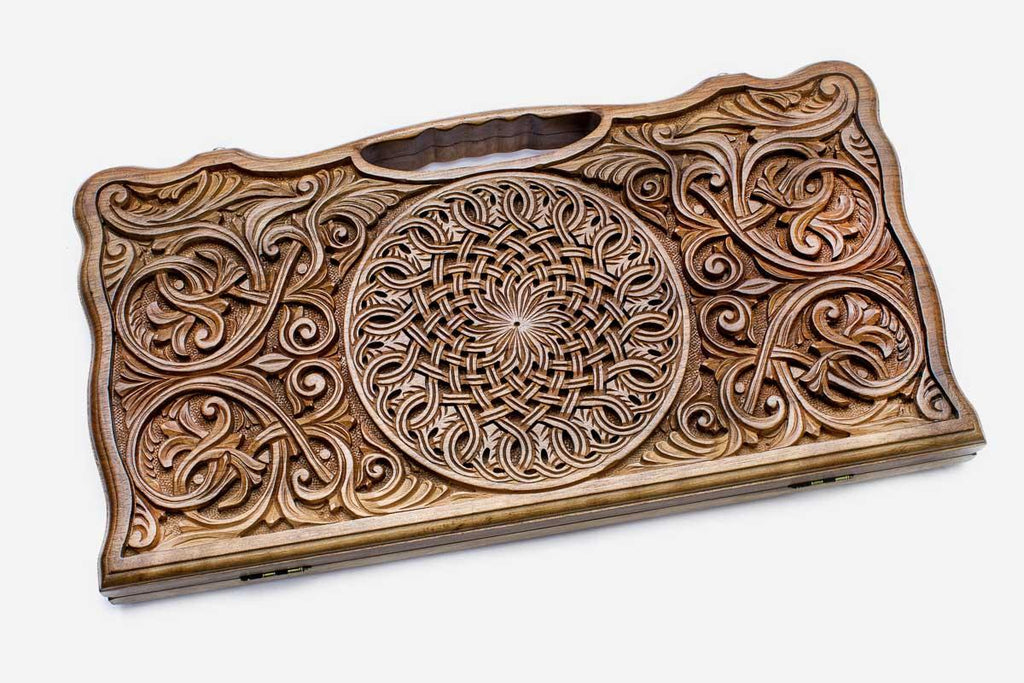 Angled view of the rosette and scrollwork master walnut backgammon board