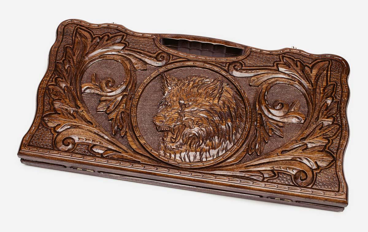 Carved beechwood backgammon board with a lone wolf medallion and a carry handle, propped open