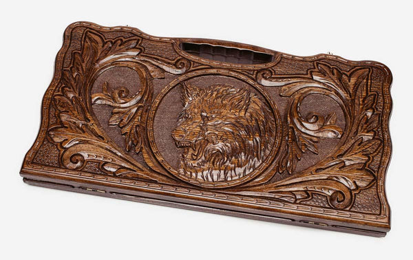 Carved beechwood backgammon board with a lone wolf medallion and a carry handle, propped open
