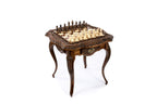 Ornately carved chess table with floral border and basket-weave legs